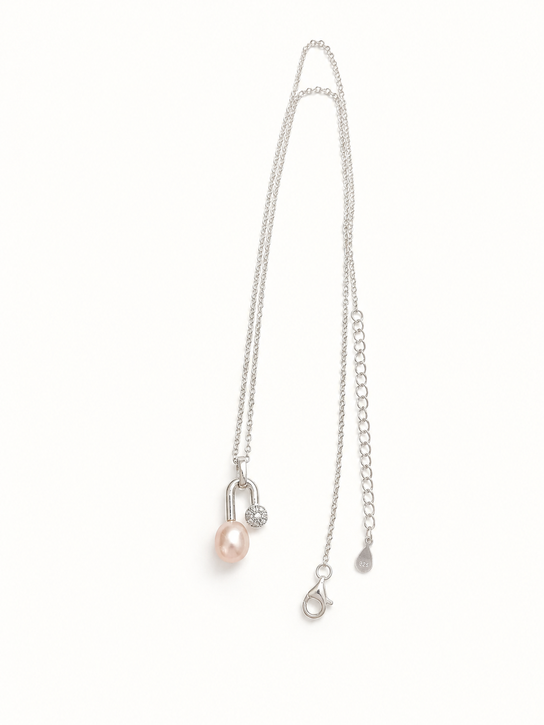 A delicate silver chain necklace featuring a small light pink pearl pendant and a silver safety pin clasp, displayed on a clean white background.