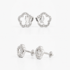 A pair of silver stud earrings with a flower-shaped outline set with small clear stones, shown from both front and side angles on a white background.
