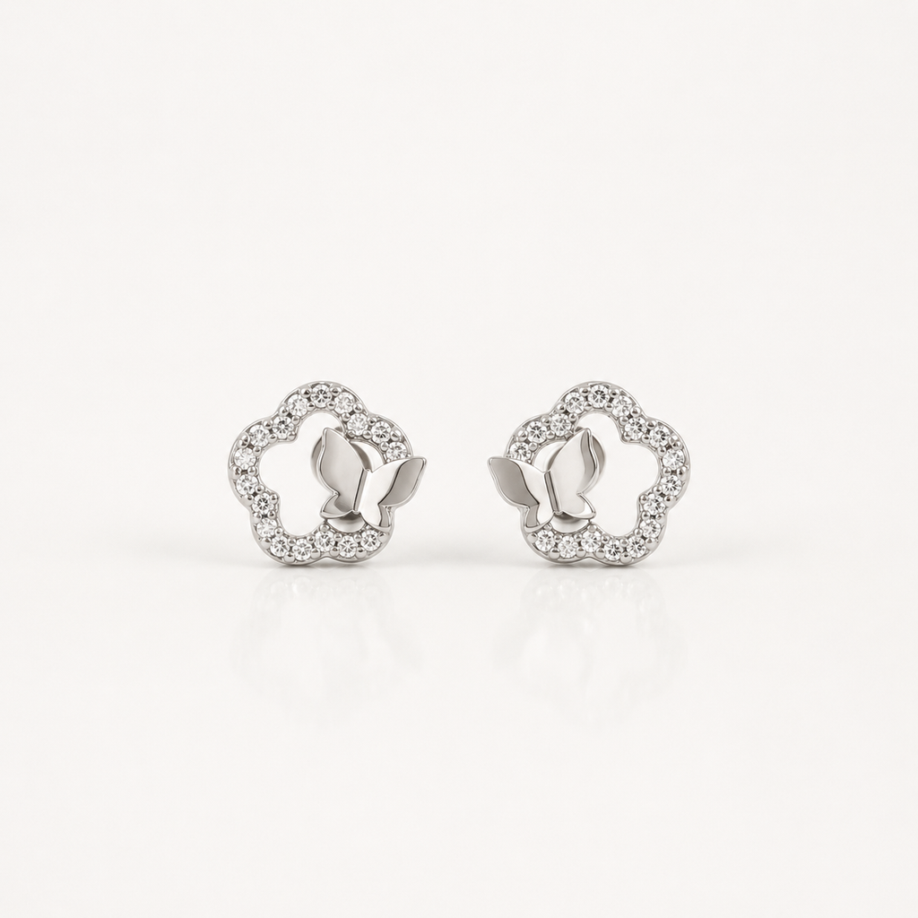 A pair of silver-toned butterfly stud earrings with a delicate border of small clear stones, displayed on a clean white background.