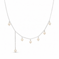 A delicate silver-toned necklace featuring five small, round off-white pearl drops arranged in a cascading V-shape on a plain white background.