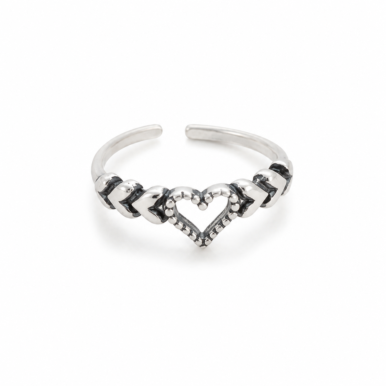 A silver-toned toe ring featuring a central heart design with small clear stones and alternating polished and textured chevron details, shown on a plain white background.