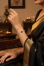 Bracelet styled with a black saree in a festive setting