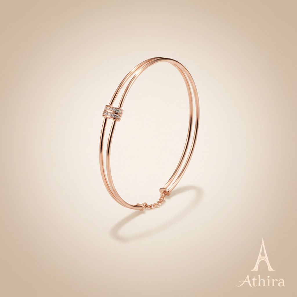 Rose gold kada on soft beige background with Athira logo